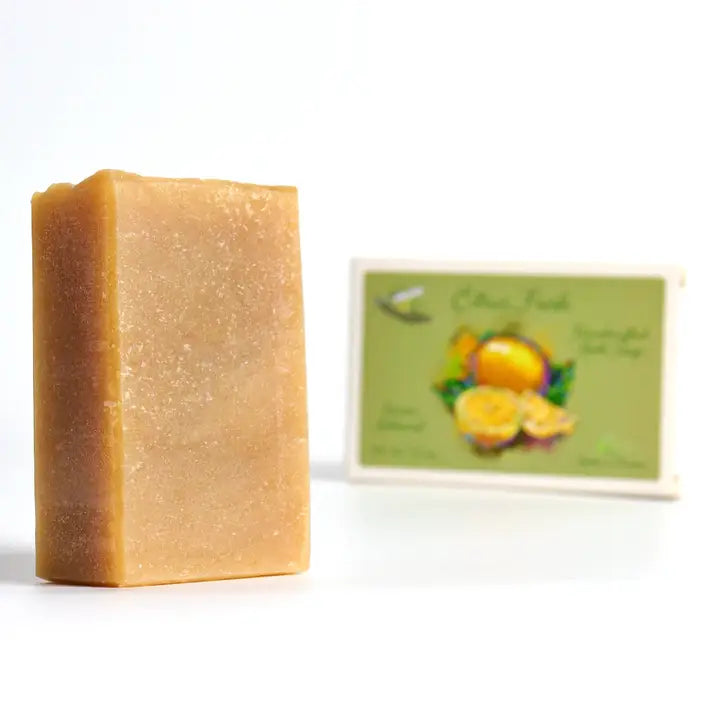 Bar of soap with a label featuring fruits on a white background