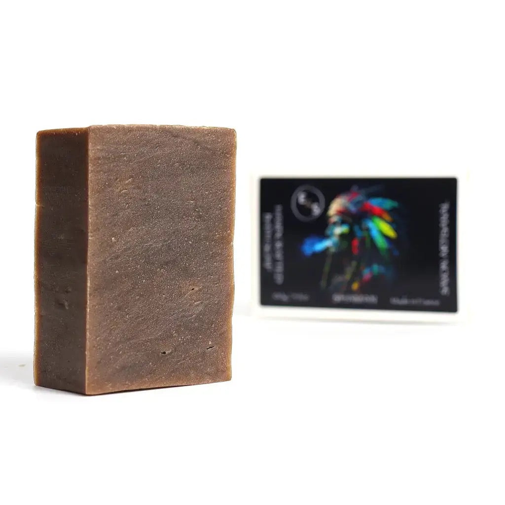 Bar of brown soap with a black box featuring colorful graphics in the background