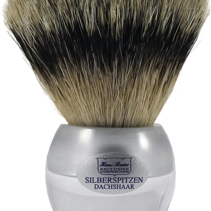 Shaving brush with silver handle and natural bristles on a white background