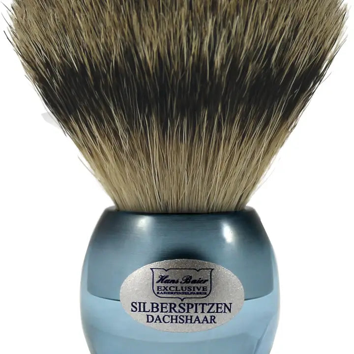 Shaving brush with blue handle and brown bristles on a white background
