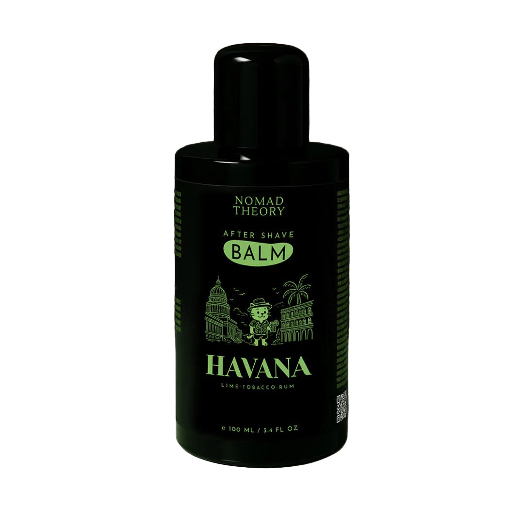 Black bottle of Nomad Theory Havana after shave balm on a marble surface with a dark background