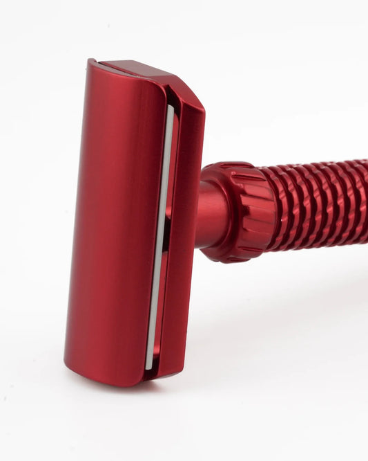 Red safety razor on a white background