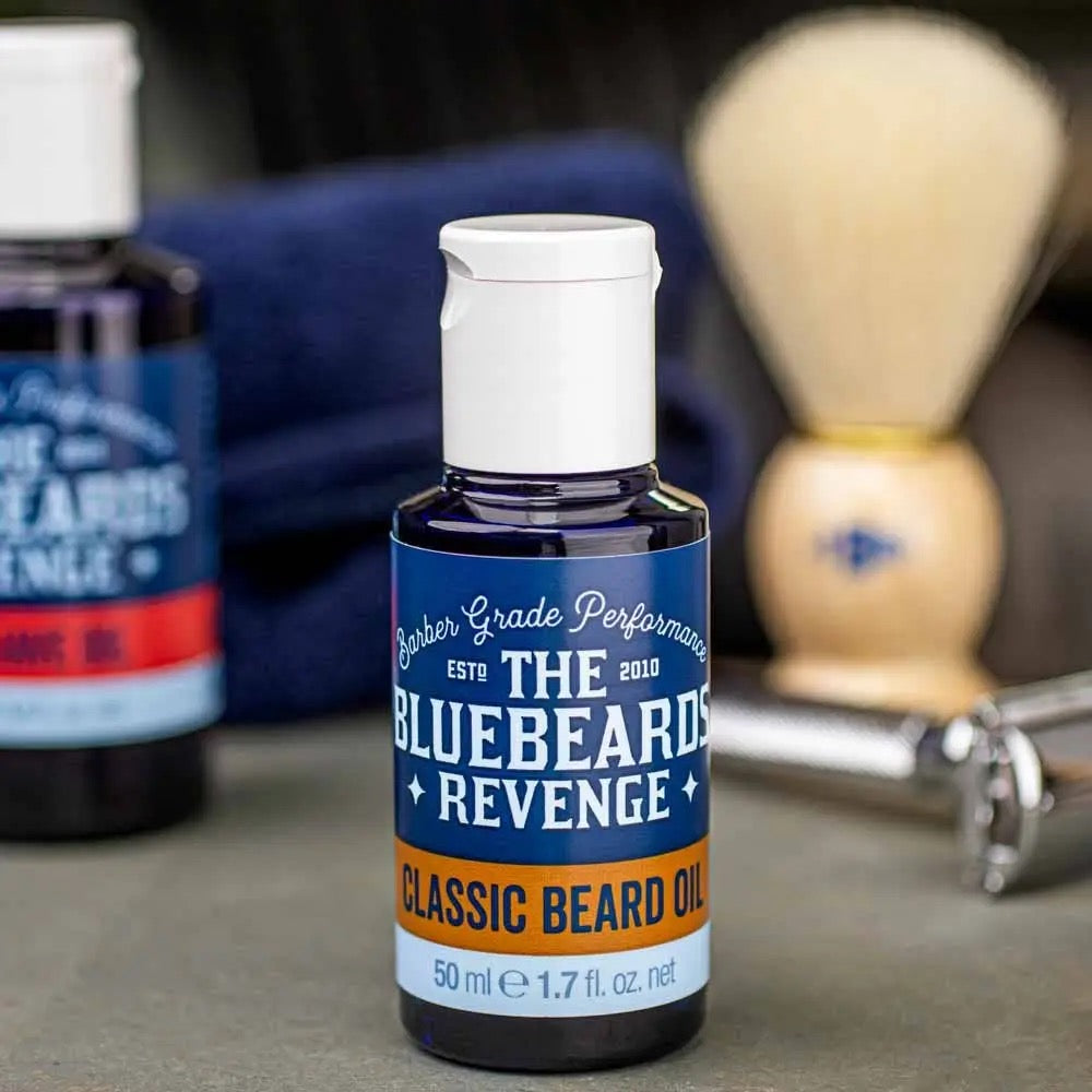 Bluebeard Revenge beard oil bottle with grooming tools in the background