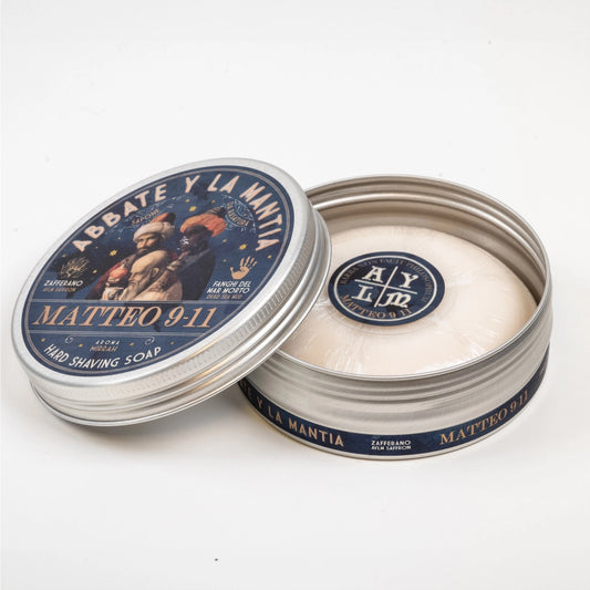 Shaving soap in a metal tin with decorative label on a white background