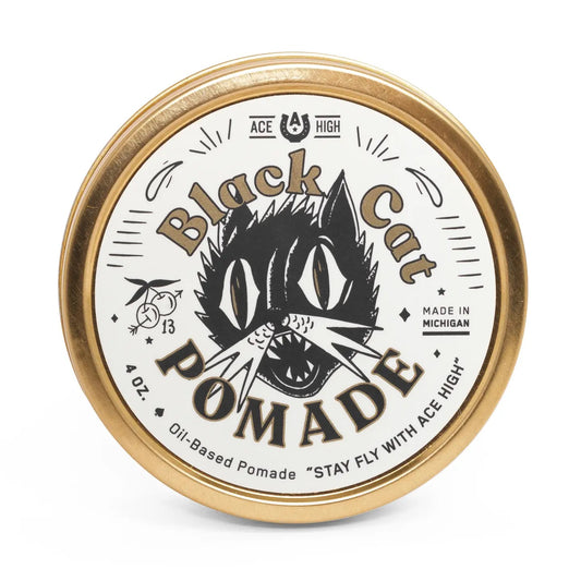 Black Cat Pomade container with gold lid on a white background