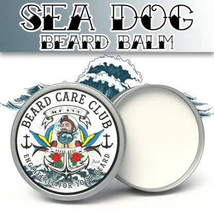 Beard balm tin with its lid off, showing the white balm inside. The round tin features a detailed nautical illustration with an anchor, ship wheel, and red roses, and the text 'BEARD CARE CLUB'.