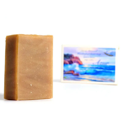 Bar of soap with a blurred beach scene in the background