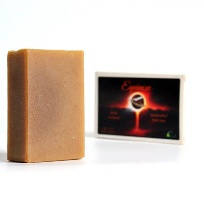 Bar of soap next to a branded soap box on a white background