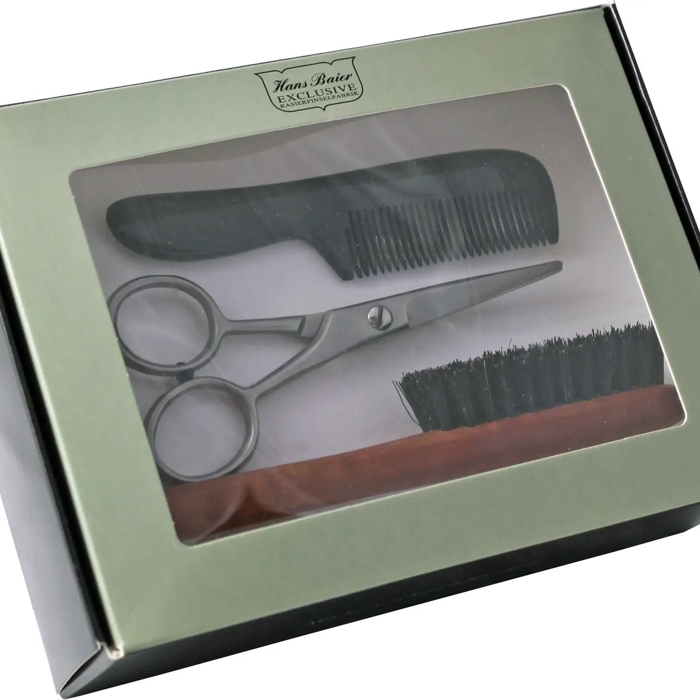 Set of grooming tools including a comb, scissors, and brush in a box with 'Hans Baier' branding.