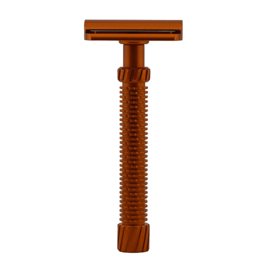 Bronze-colored safety razor on a gray background