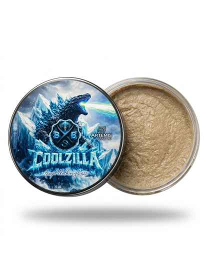 Jar of gold powder with a 'Godzilla' design on the lid against a white background